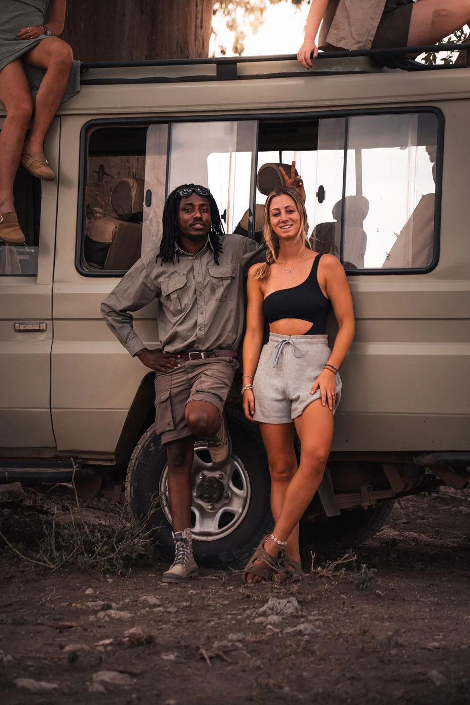 Safari Goats guide with a traveller beside the safari vehicle